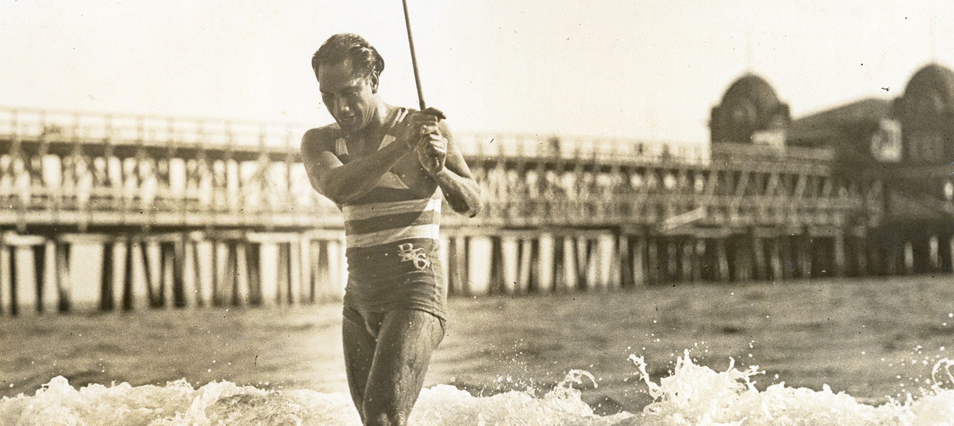 Duke walking out of the water near the pier