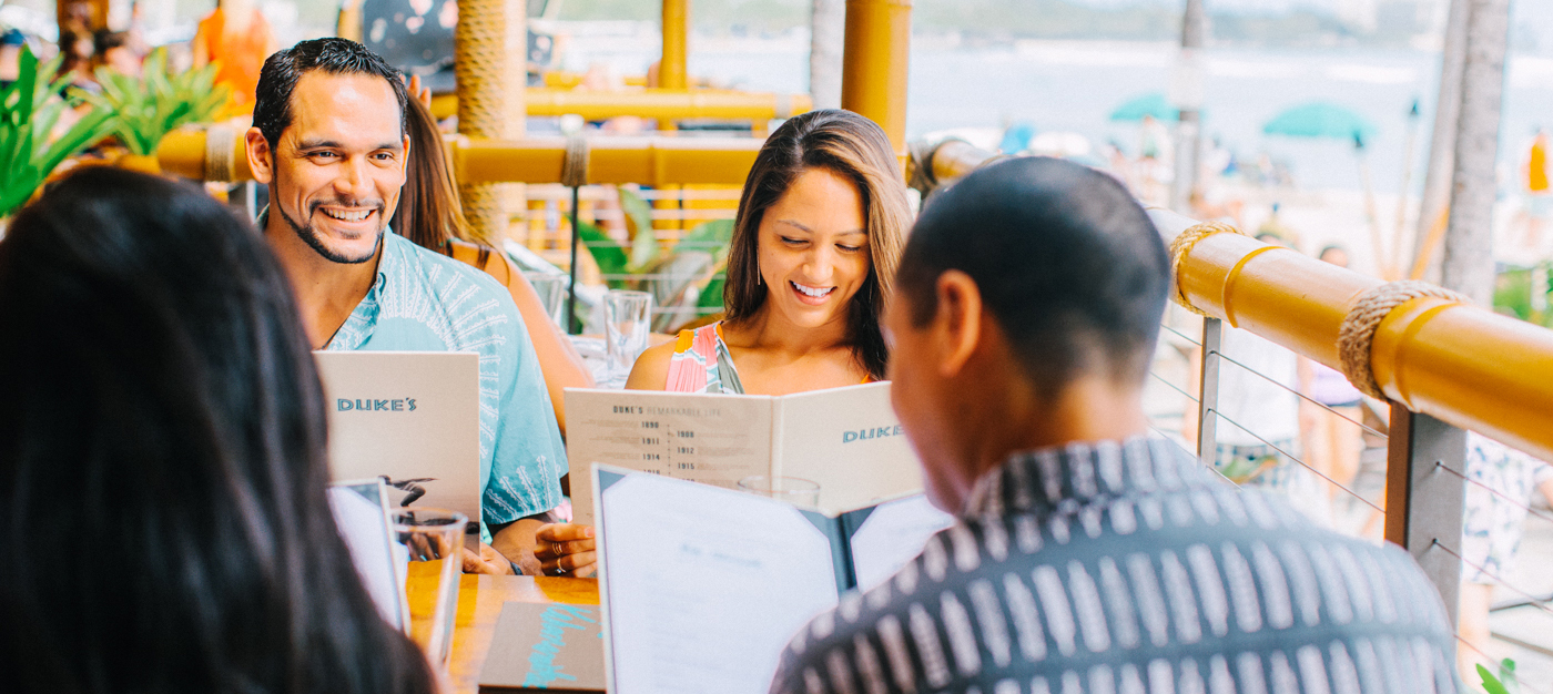 group of 4 looking at menus